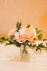 A small bouquet of pink and white roses in a vase for a tabletop setting  idea at a wedding, birthday, anniversary, or other formal romantic occasion. 