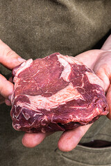 Food photo meat steak in the hands of a chef