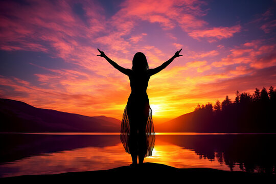 Silhouette of woman practicing mediation in beautiful landscape