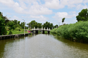 Cement bridge for cars to cross the canal with blue sky and natural background at Thailand.