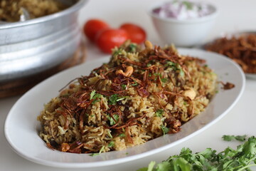 Mutton Biryani prepared with spices layered between mildly spiced ghee rice with a generous sprinkle of caramelized onions and Mutton marinated in yogurt