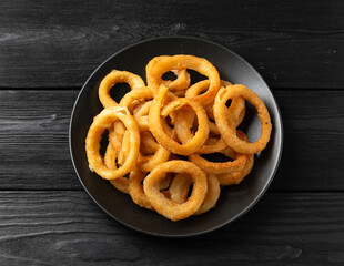 Crunchy Fried Battered onion rings on black plate