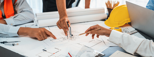 Architect or engineer working on building blueprint, contractor designing and drawing blueprint layout with tool for construction project. Civil engineer and architecture design concept. Insight