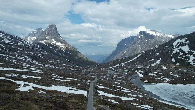 Alpine vegetation and mountain peaks with steep cliffs along Trollstigen road from Andalsnes to Stra