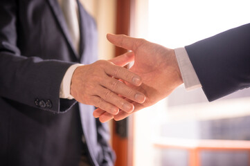 Obraz premium businessman shake hand with partner to celebration partnership and business deal concept, Businessman handshake for teamwork of business merger and acquisition, successful negotiate, hand shake