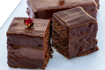 Several pieces of chocolate cake close up. Visible incision. Selective focus.