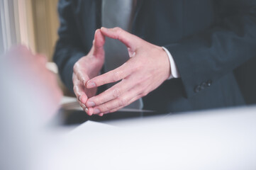 Body language concept, businessman standing with putting hands together showing positive thinking...