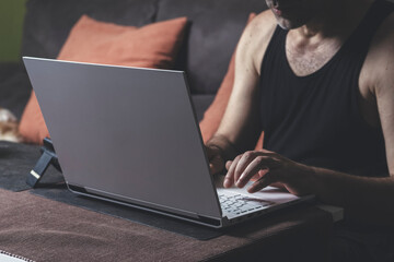 Man using laptop while sitting on sofa