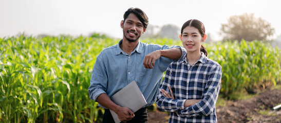 Smart farmers couple holding laptop to examining quality crop of