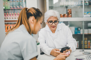 Pharmacist giving advice And advice for patients who come to buy Medicine, Drugs, Vitamins products, according to prescriptions in modern pharmacies.