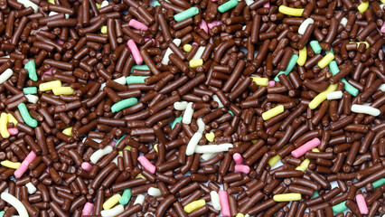 colored or colorful chocolate sprinkles. Chocolate sprinkles texture for background
