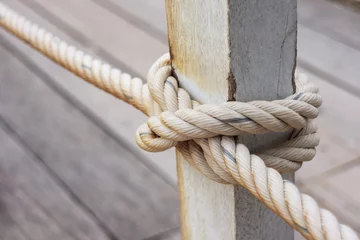 Photo sur Plexiglas Helix Bridge fence pole tied with rope, rope knot on fence of wooden bridge