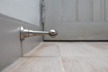 stainless steel magnetic door stopper, suction type doorstop, vintage interior, shallow depth of...
