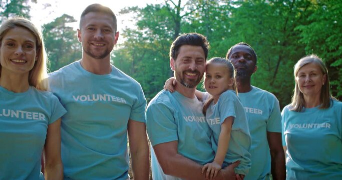 Team of young multicultural volunteer enjoy charitable social work in tree forest planting. Non-govermental organisationwork for fighting climate change and global warming in environmental project