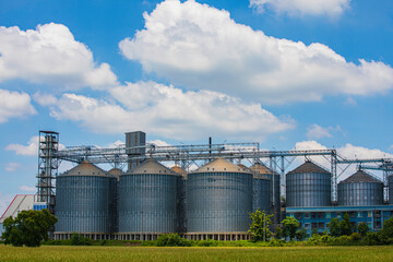 Plant for the drying and storage stainless silo grain. Rice plant in the middle of fields.