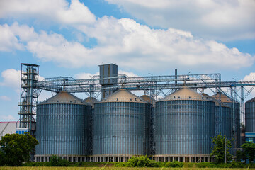 Plant for the drying and storage stainless silo grain. Rice plant in the middle of fields.