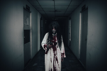 Naklejka premium Portrait of asian woman make up ghost,Scary horror scene for background,Halloween festival concept,Ghost movies poster,angry spirit in the apartment
