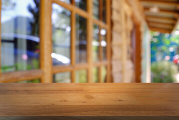 Empty wooden table in front of abstract blurred background of coffee shop . can be used for display or montage your products.Mock up for display of product.