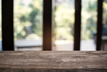 Empty wooden table in front of abstract blurred background of coffee shop . can be used for display or montage your products.Mock up for display of product.