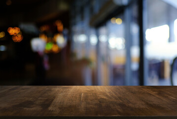 Empty wooden table in front of abstract blurred background of coffee shop . can be used for display or montage your products.Mock up for display of product
