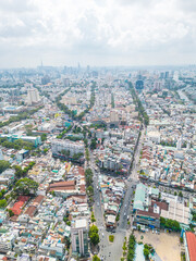 Fototapeta na wymiar Aerial view of Ho Chi Minh City skyline and skyscrapers in center of heart business at Ho Chi Minh City downtown. Cityscape and many buildings, local houses