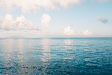 Seascape skyline of tropical beach at sunrise. Picturesque fabulous seascape, cloudy landscape, nature.