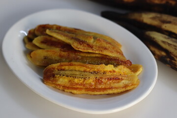 Caramelised plantain slices. Long slices of ripe plantain roasted with ghee and sugar on a griddle. A traditional tea time snack from Kerala