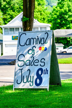 the small town of Unadilla is having a Street Sale and the signs on the corner of the road are up.  Folding Panel advertisement for the Sidewalk Sale in Upstate NY town.