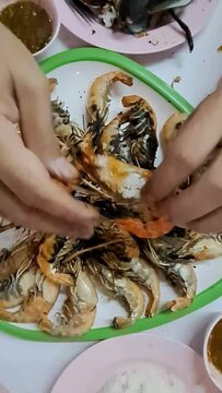 person holding a bowl of mussels