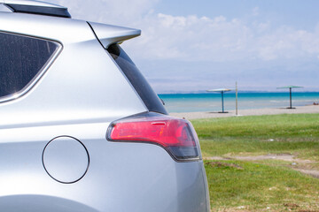 View of the car and Issyk-Kul lake with mountains, Kyrgyzstan