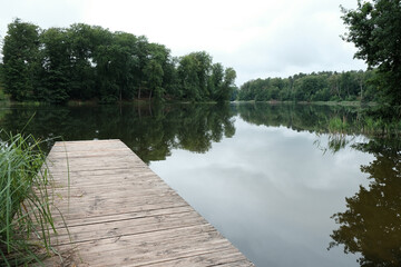 calm pier on a peaceful wood lake