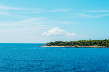 Sea coast with lighthouse and clear blue sky. Adriatic sea, Croatia