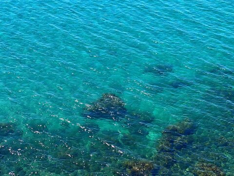 Blue azure ocean water shiny rippled surface.