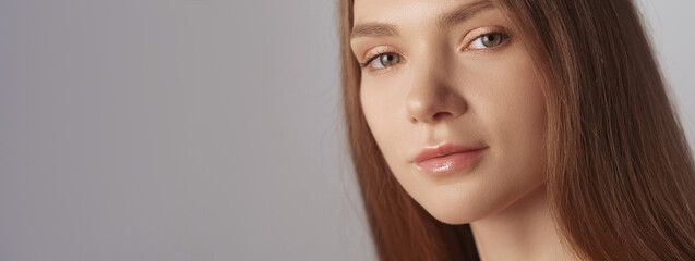 Naklejka premium Perfect skin. Face wellness. Facial cosmetics. Beautiful flawless confident smiling fair hair woman with natural makeup isolated on beige background empty space.