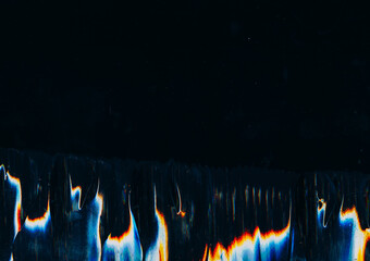 Glitch interference. Old film. Distorted background. Digital background with blurred fire imitating blue orange flare vibration texture on black.