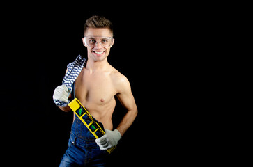 Young attractive handyman posing in a photo studio.