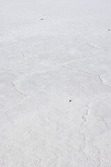 Exploring the huge salt flats Salinas Grandes de Jujuy in northern Argentina while traveling South America - close up of the surface