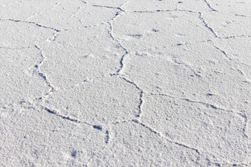 Exploring the huge salt flats Salinas Grandes de Jujuy in northern Argentina while traveling South America - close up of the surface