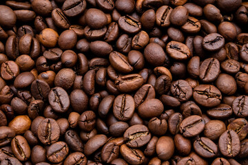 A close-up of roasted coffee beans can be used as a background for your coffee project