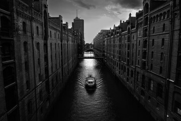Boat on the Kehrwiederfleet Canal in the Speicherstadt Warehouse District of Hamburg in Black and White