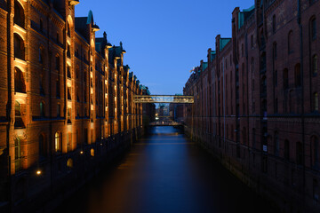 Hamburg Speicherstadt Warehouse District with Illuminated Brick Facades at the Kehrwiederfleet Canal in the Evening at Dusk