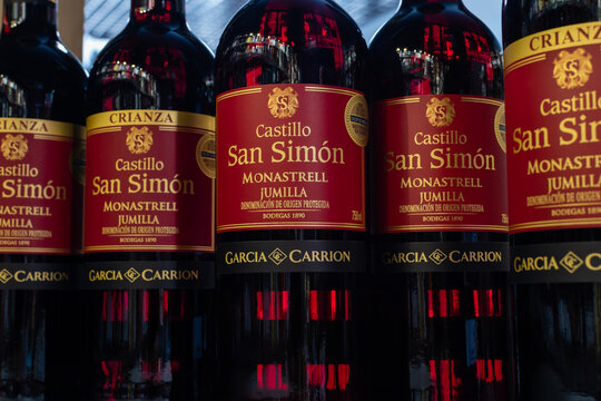 Bottles of Spain red wine San Simon Monastrell Jumilla close-up on blurred background of wine shelves. Ukraine, Zhytomyr, July, 05, 2023