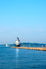 Fototapeta premium Spring Point lighthouse on a warm summer evening in Portland Maine. Windjammers, favorite tourist attraction 