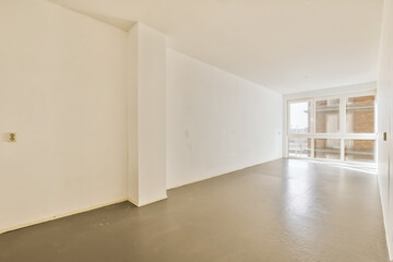 Fototapeta premium an empty room with white walls and black floor, there is a door in the corner to the left side