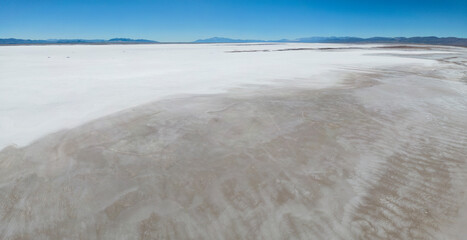 Aerial view of the huge salt flats Salinas Grandes de Jujuy in northern Argentina while traveling South America - Panorama