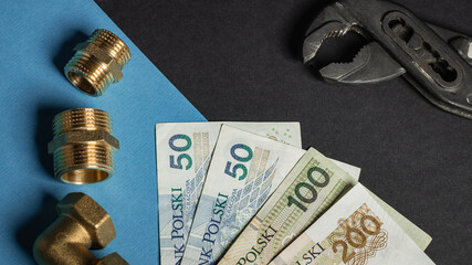 warsaw, poland - 07 07 2023: Polish banknotes of PLN on a black and blue background, next to the...