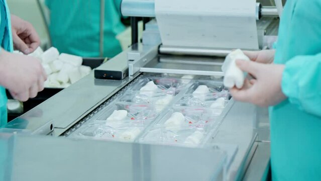 Factory workers packaging medical products. Production of speculum gynecological. Conveyor belt of factory line. Manufacturing line. Medical equipment. Close-up in 4K, UHD