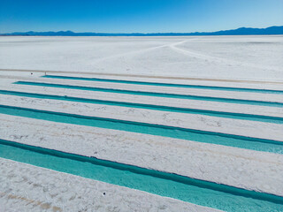 Aerial view of the salt basins in the salt crust of the huge salt flats Salinas Grandes de Jujuy in northern Argentina while traveling South America