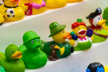 Toy rubber ducks with different characterizations, on a store shelf.