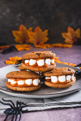 Gingerbread cookies with marshmallow teeth on a halloween plate vertical view